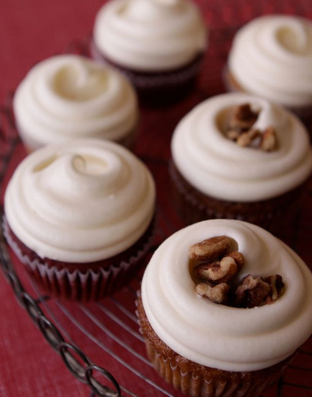 Cupcakes with white frosting and pecans on top