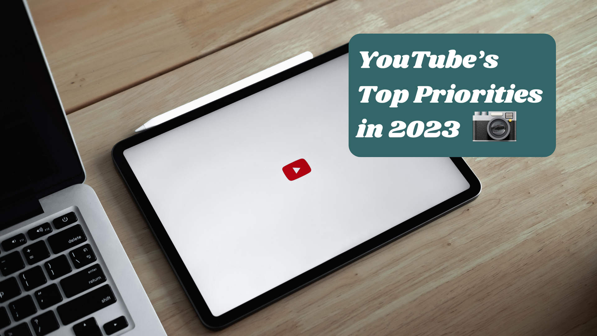 A tablet with a youtube logo on it is on a wooden table next to a laptop.