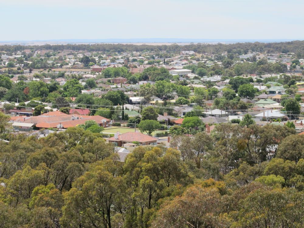 An Aerial View of a Residential Area Surrounded by Trees and Houses — Brett Negus Plumbing In Maryborough, QLD