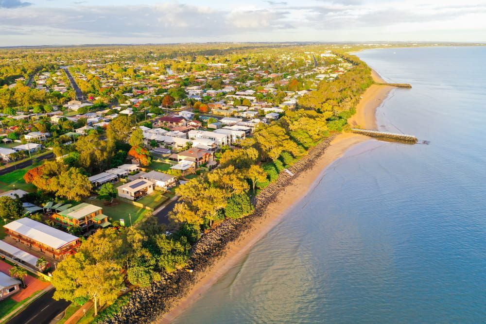 An Aerial View of a Beach With a City in the Background — Brett Negus Plumbing In Maryborough, QLD