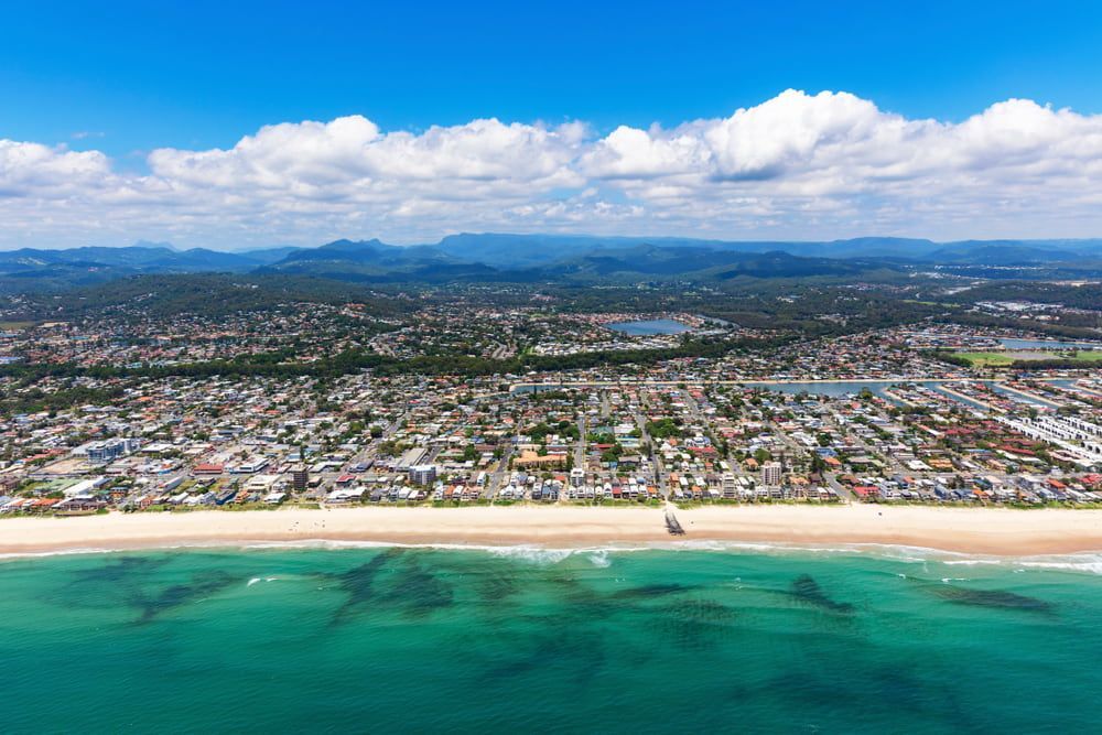 An Aerial View of a Beach With a City in the Background — Brett Negus Plumbing In Oakhurst, QLD