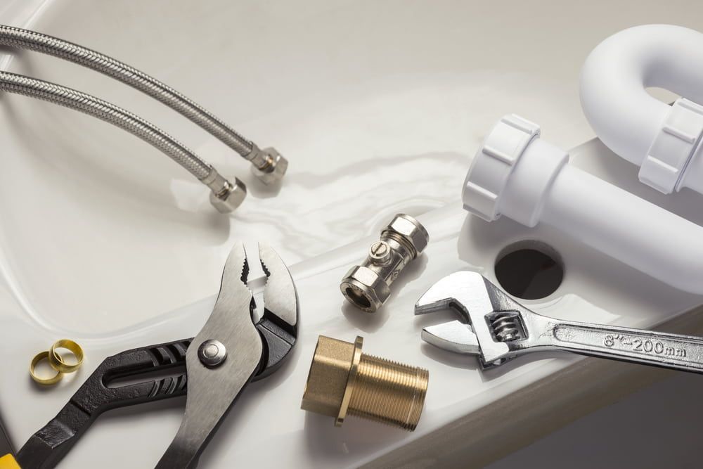 A Sink With a Wrench and Pliers on It — Brett Negus Plumbing In Hervey Bay, QLD