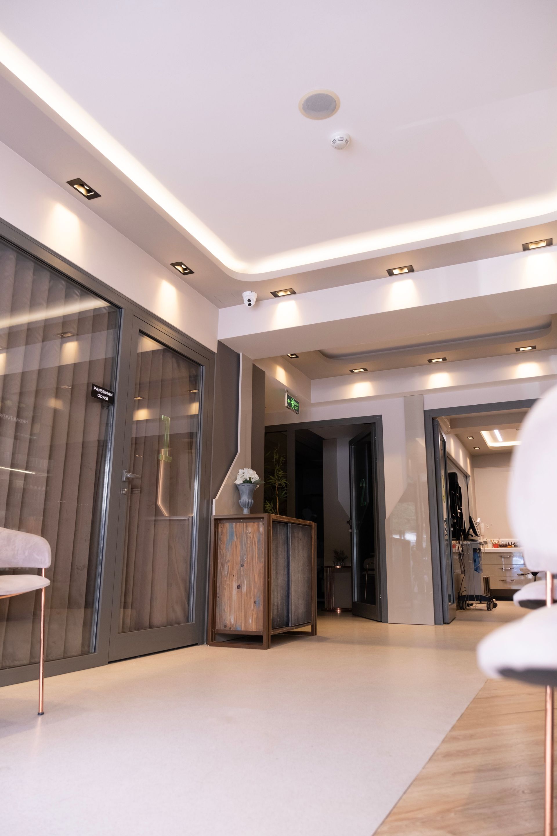 Modern salon interior with mirrors, styling chairs, and warm recessed lighting
