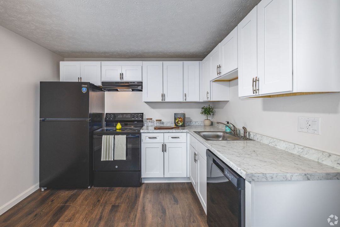 Interior Photo of 860 East Kitchen with White Cabinets and Black Appliances