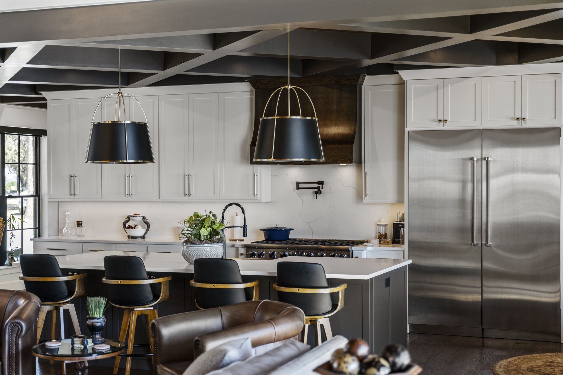 A kitchen with stainless steel appliances and white cabinets