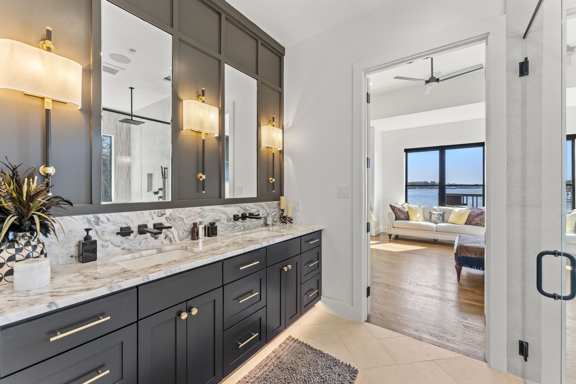A bathroom with two sinks and two mirrors in a house.
