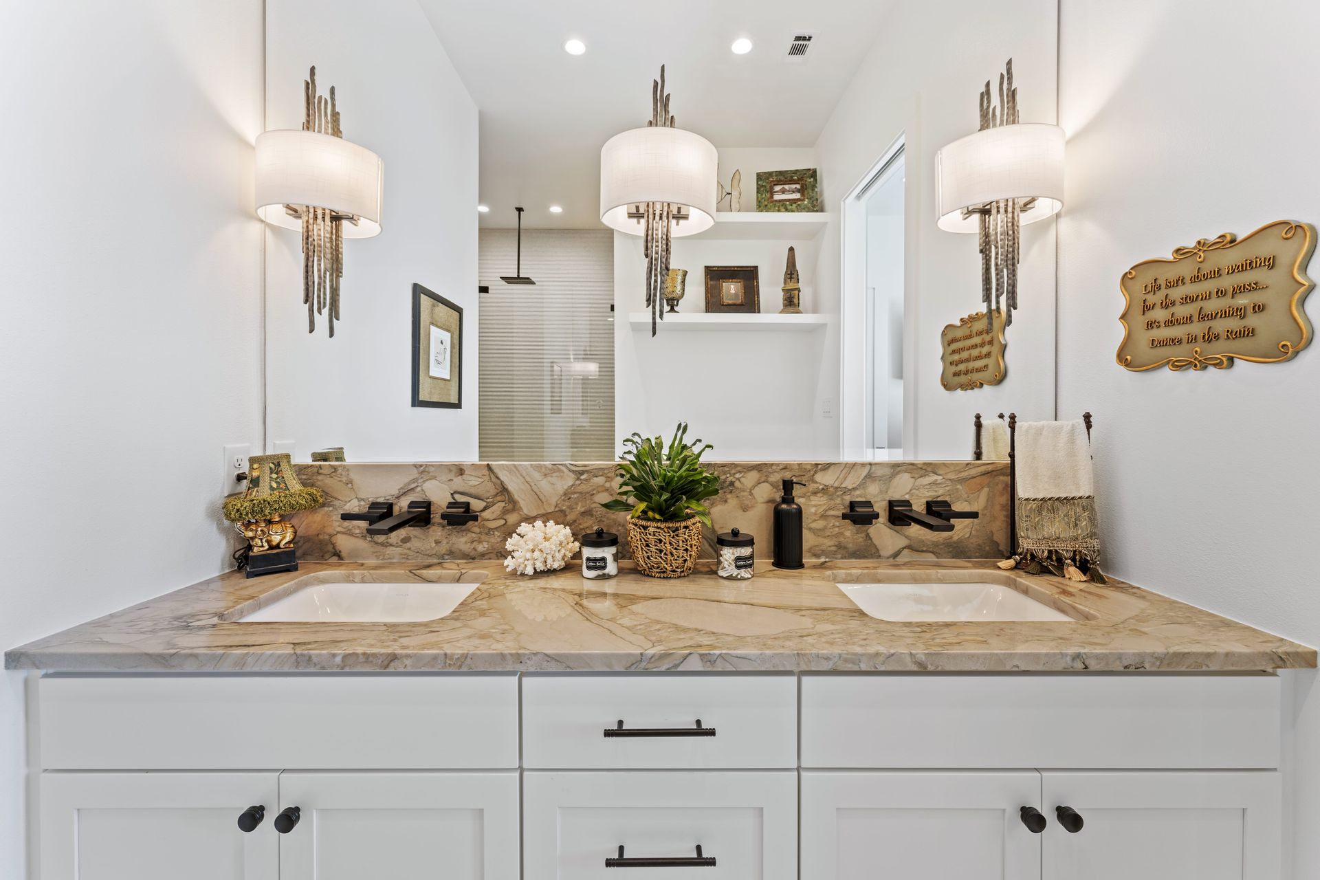 A bathroom with two sinks and a large mirror.