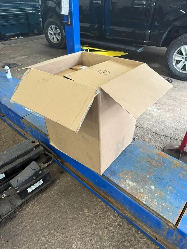 Auto Repair Parts And Supplies On Vehicle Service Lift | Your Neighborhood Mechanic LLC