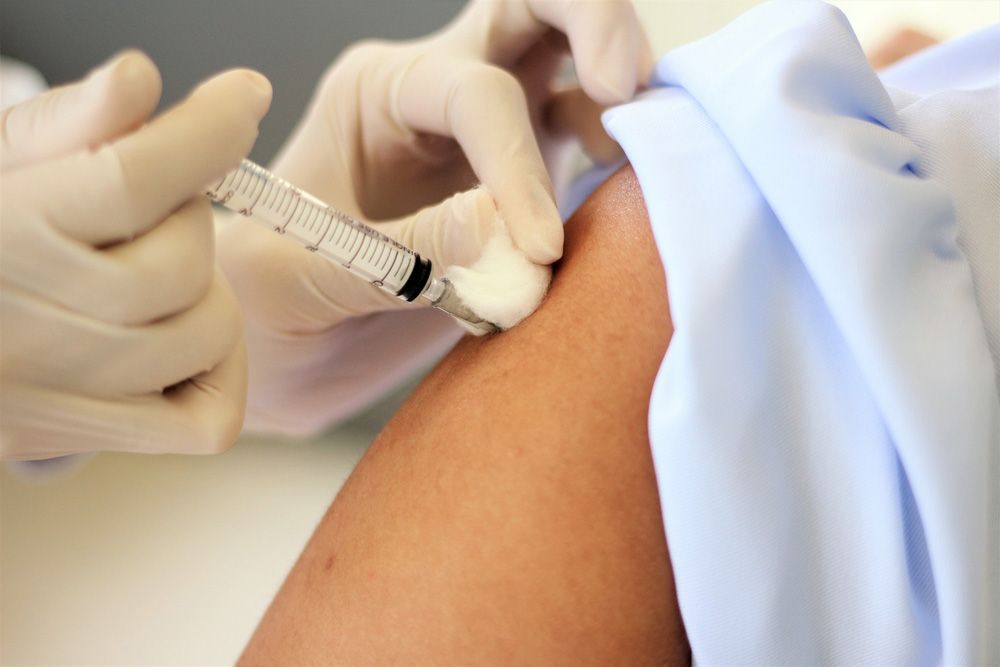 A Person is Getting an Injection in Their Arm — Mount Archer Medical Centre in Berserker, QLD