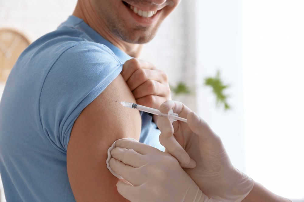 A Man is Getting an Injection in His Arm — Mount Archer Medical Centre in Berserker, QLD