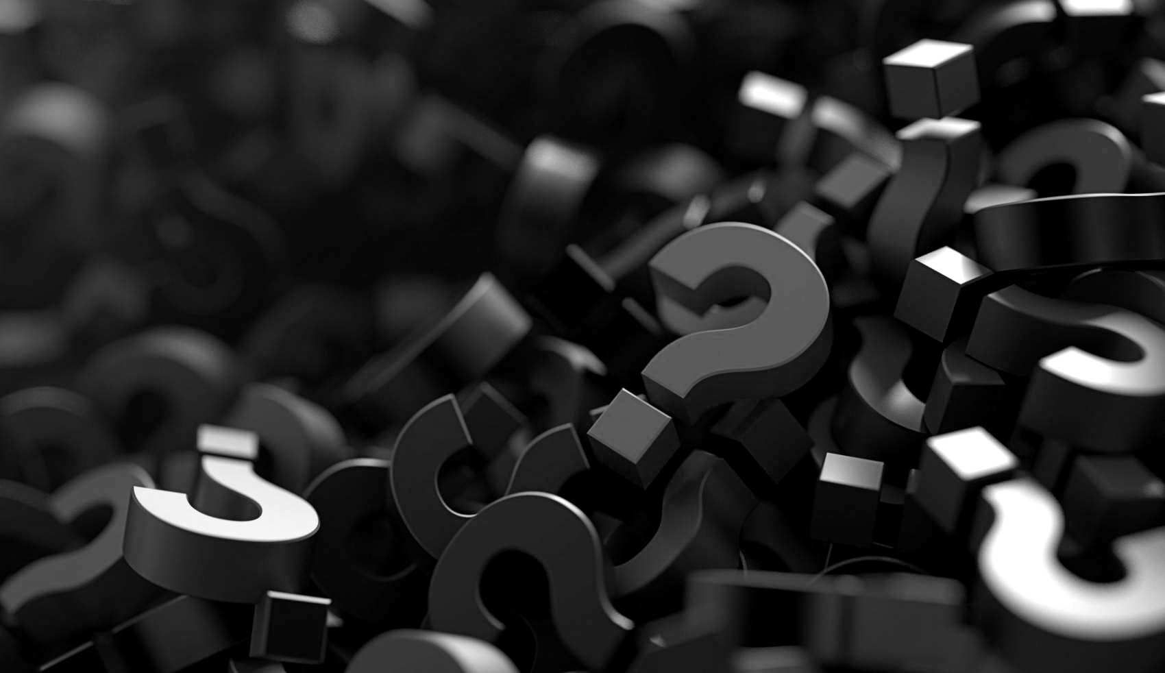 Black question marks and symbols scattered on a dark background