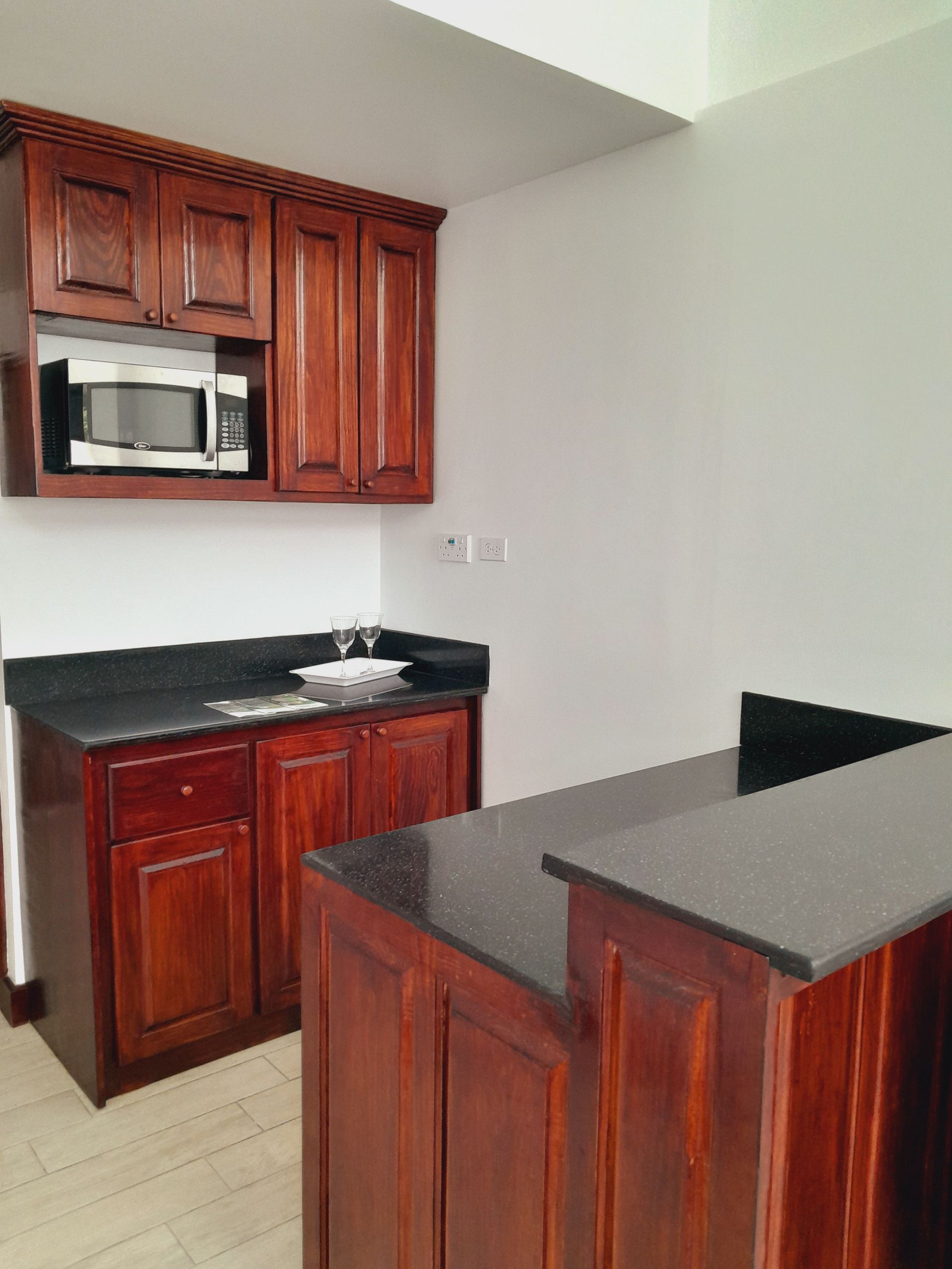 A kitchen with wooden cabinets and granite counter tops
