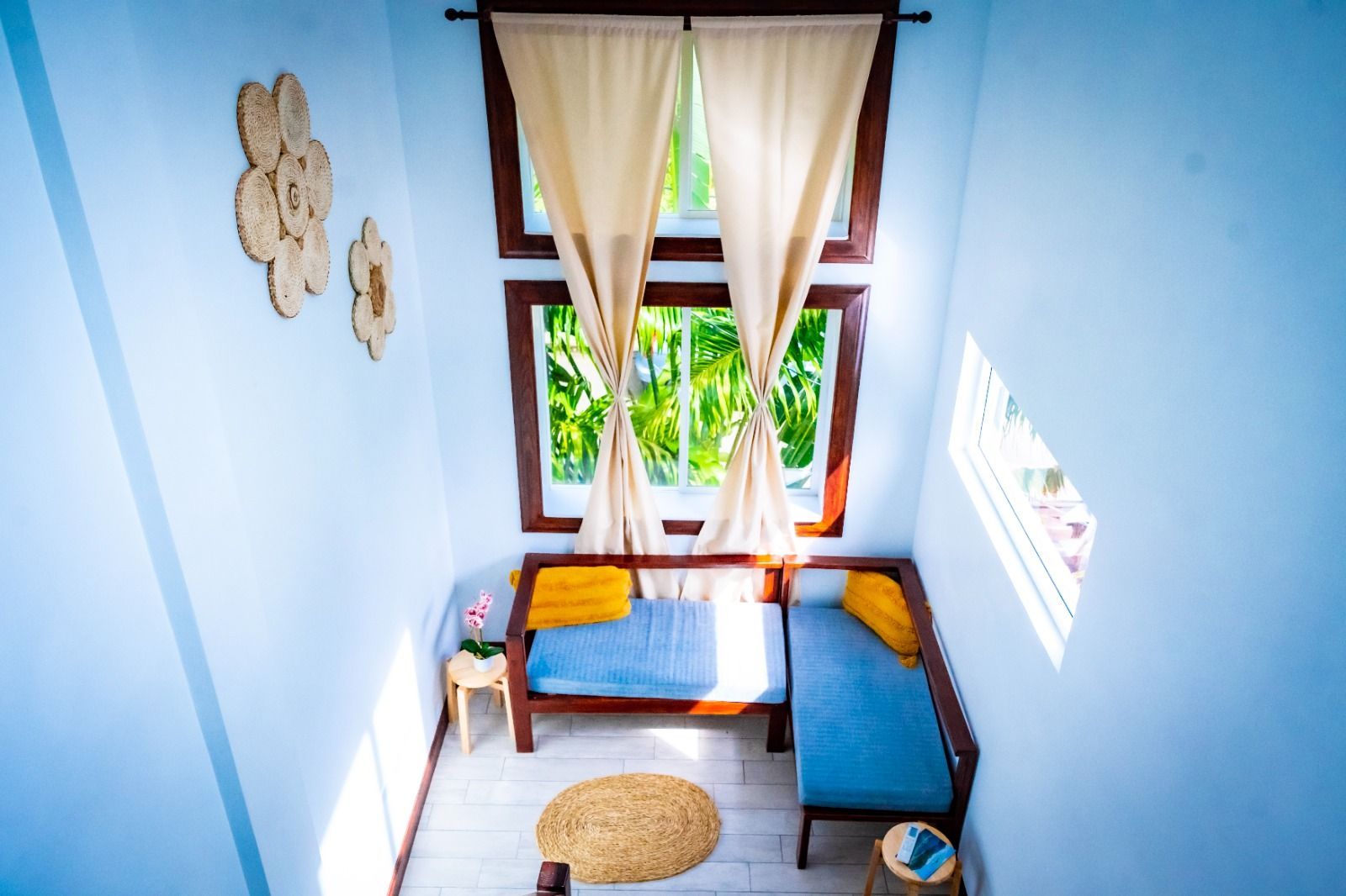 An aerial view of a bedroom with two beds and two windows.