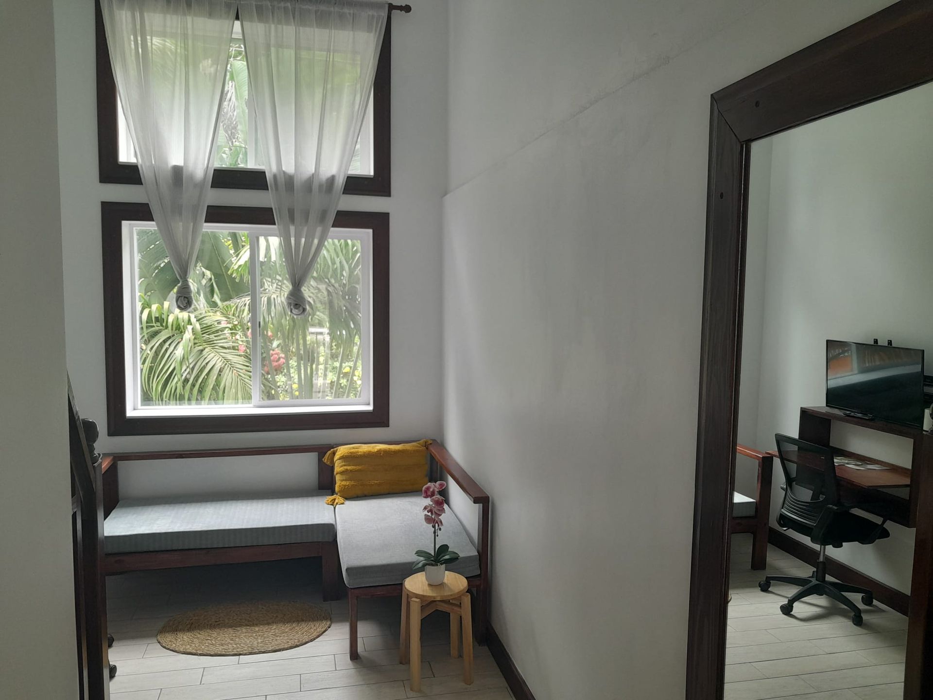 A room with a couch and a desk in it