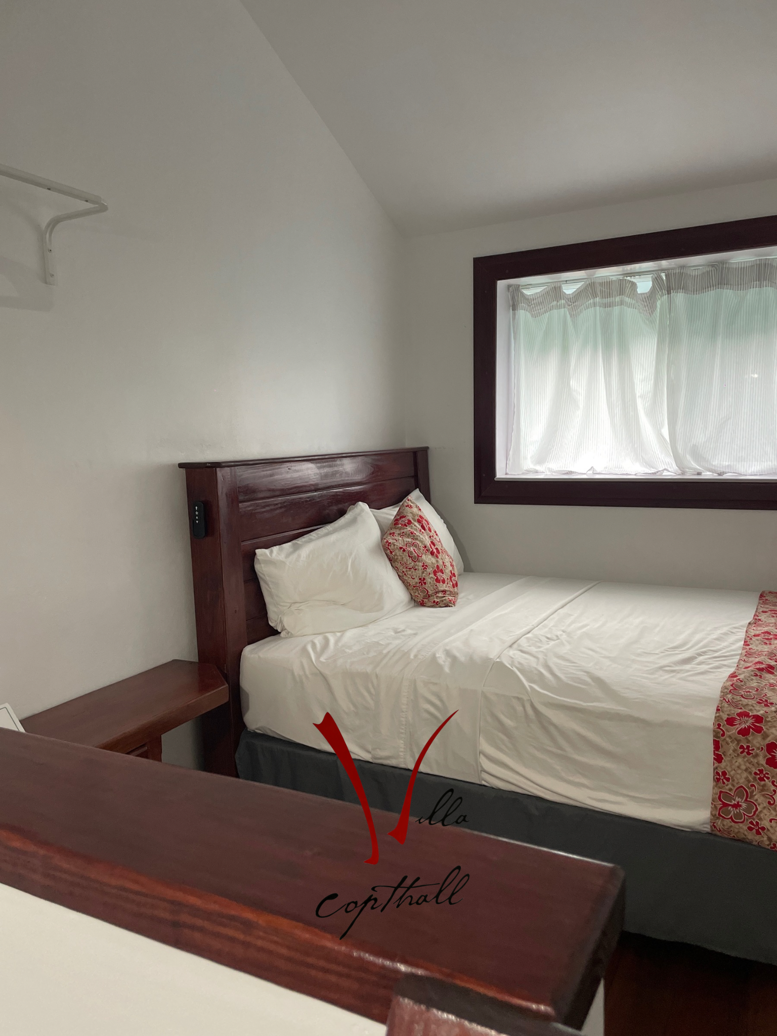 A hotel room with a bed and a window