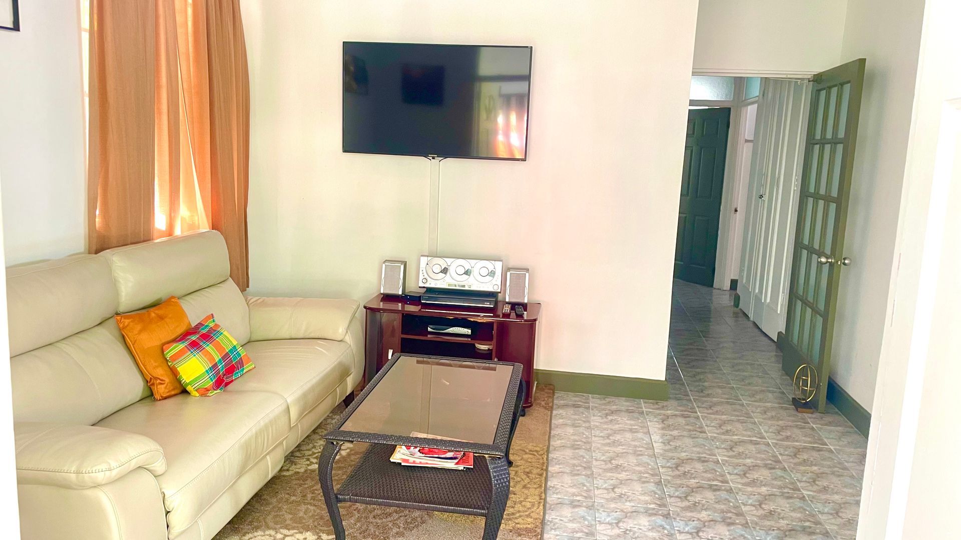 A living room with a couch , coffee table and television.