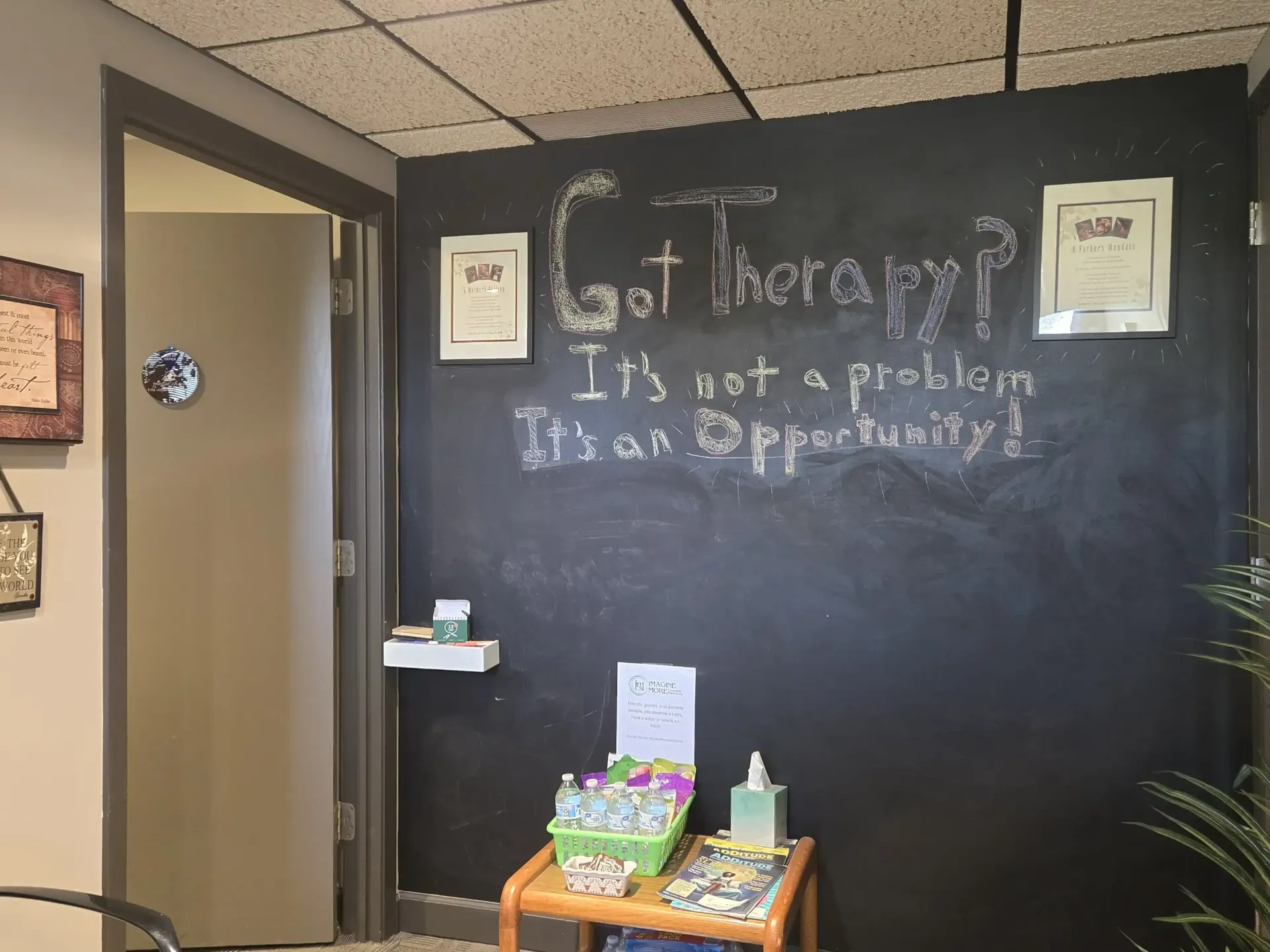 A black chalkboard wall in a professional office reads 