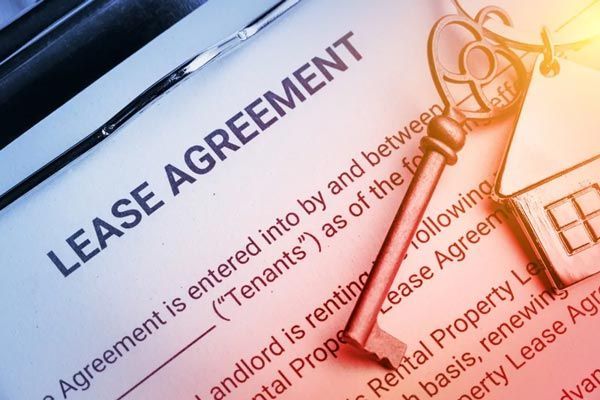 A lease agreement with a key on top of it