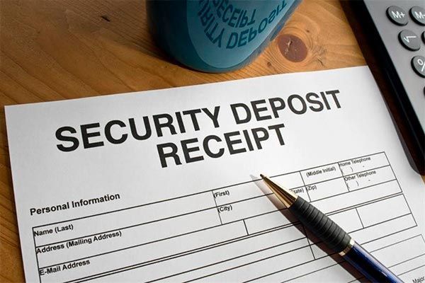 A security deposit receipt with a pen and calculator