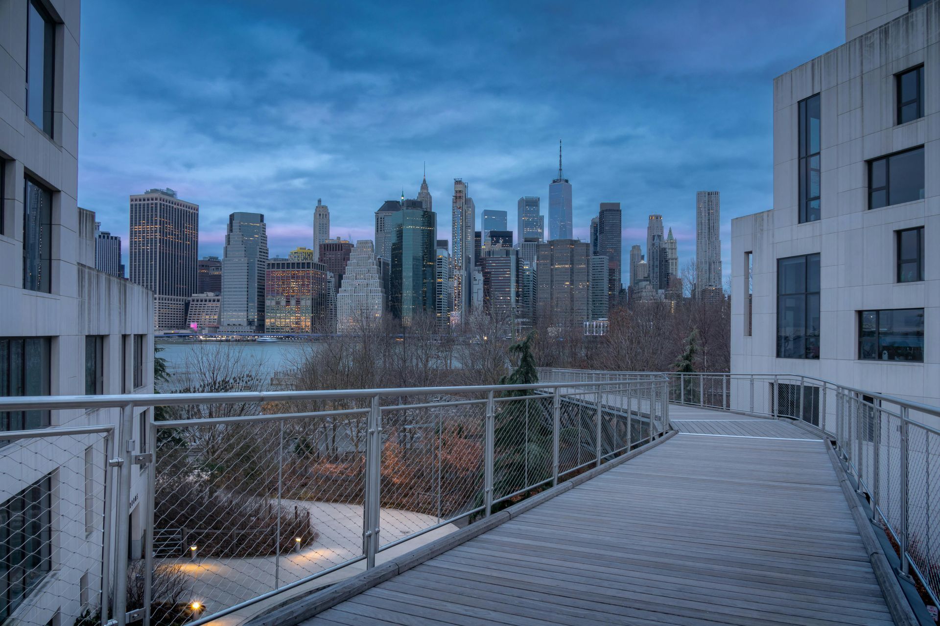 There is a bridge leading to the city skyline.