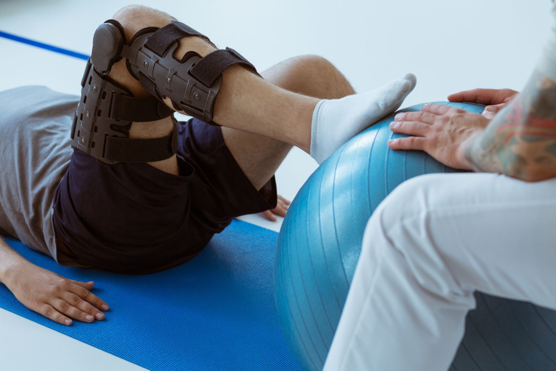 Patient doing knee therapy with balance ball at AMP Physical Therapy in Middlesex County NJ.