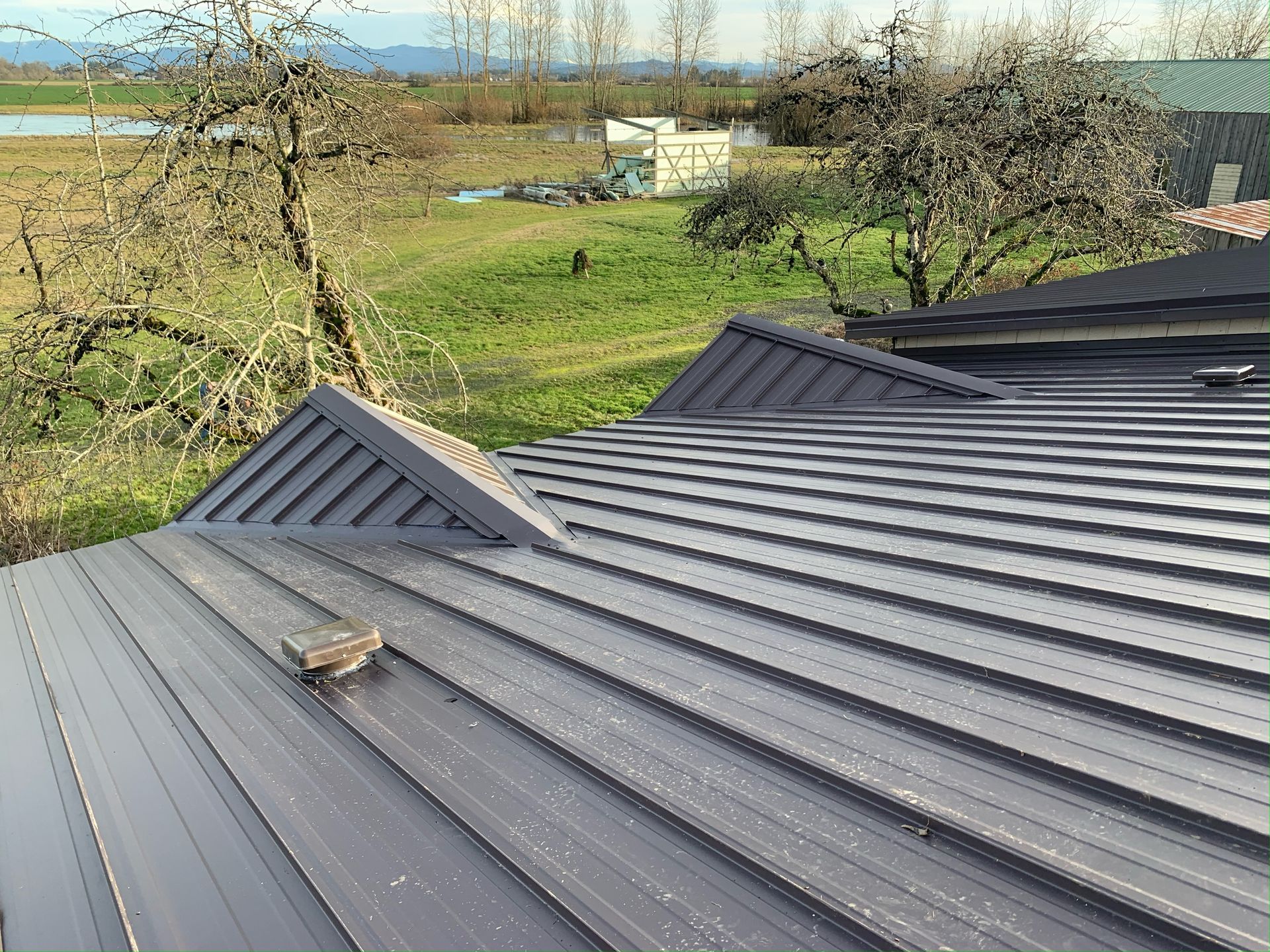 A close up of a roof with a view of a field.