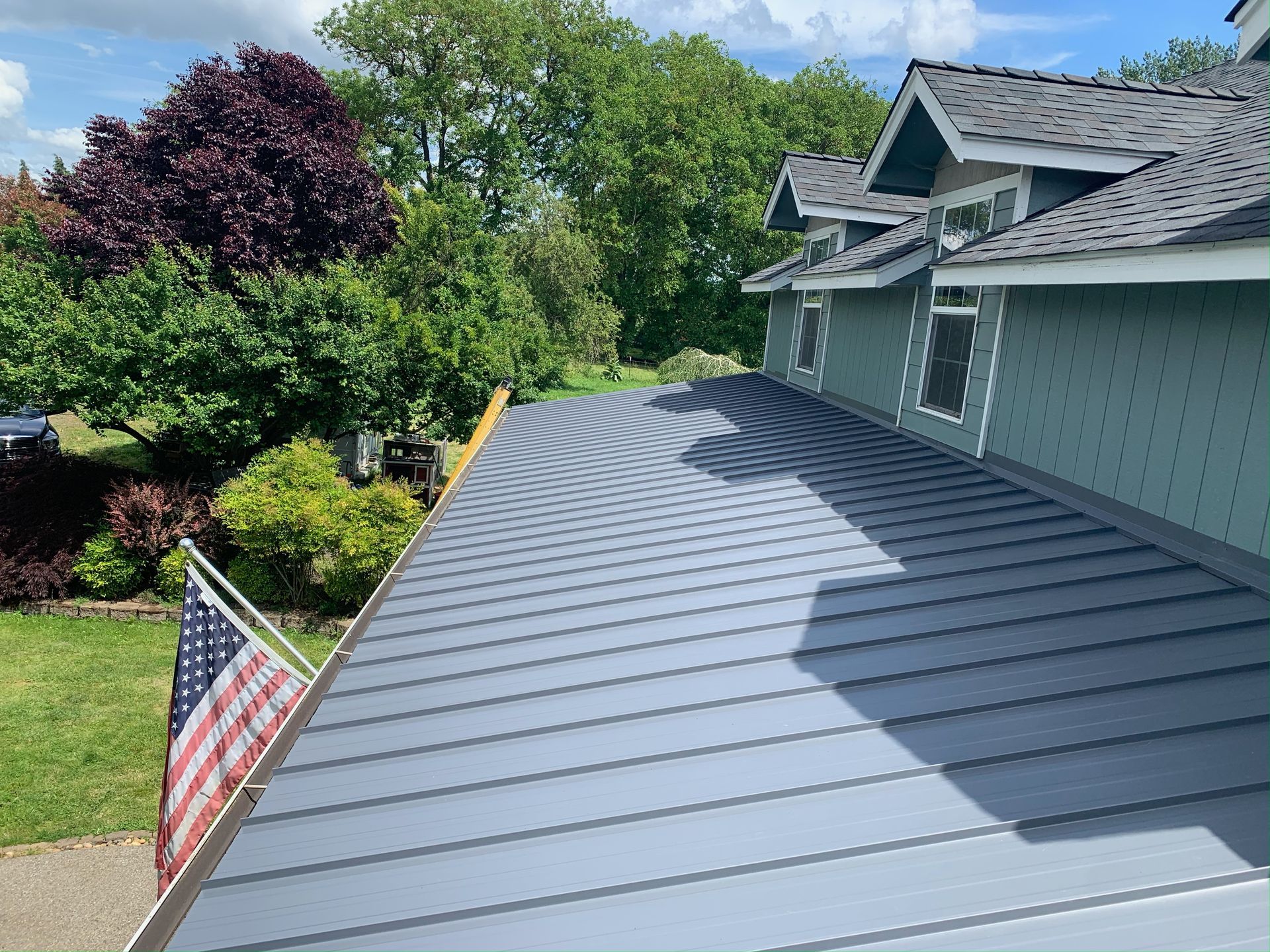 The roof of a house with an american flag on it.