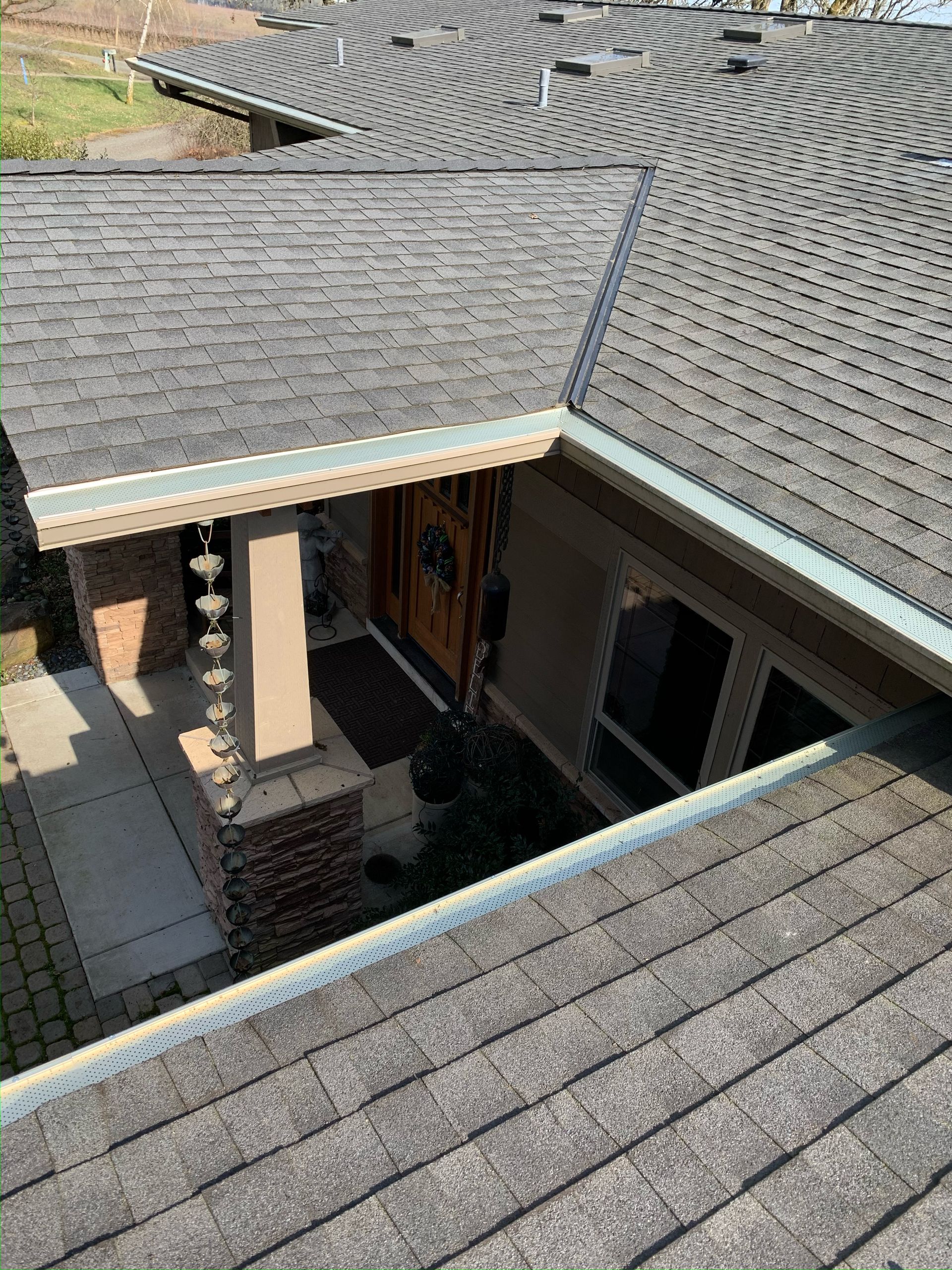 An aerial view of a house with a roof and gutters.