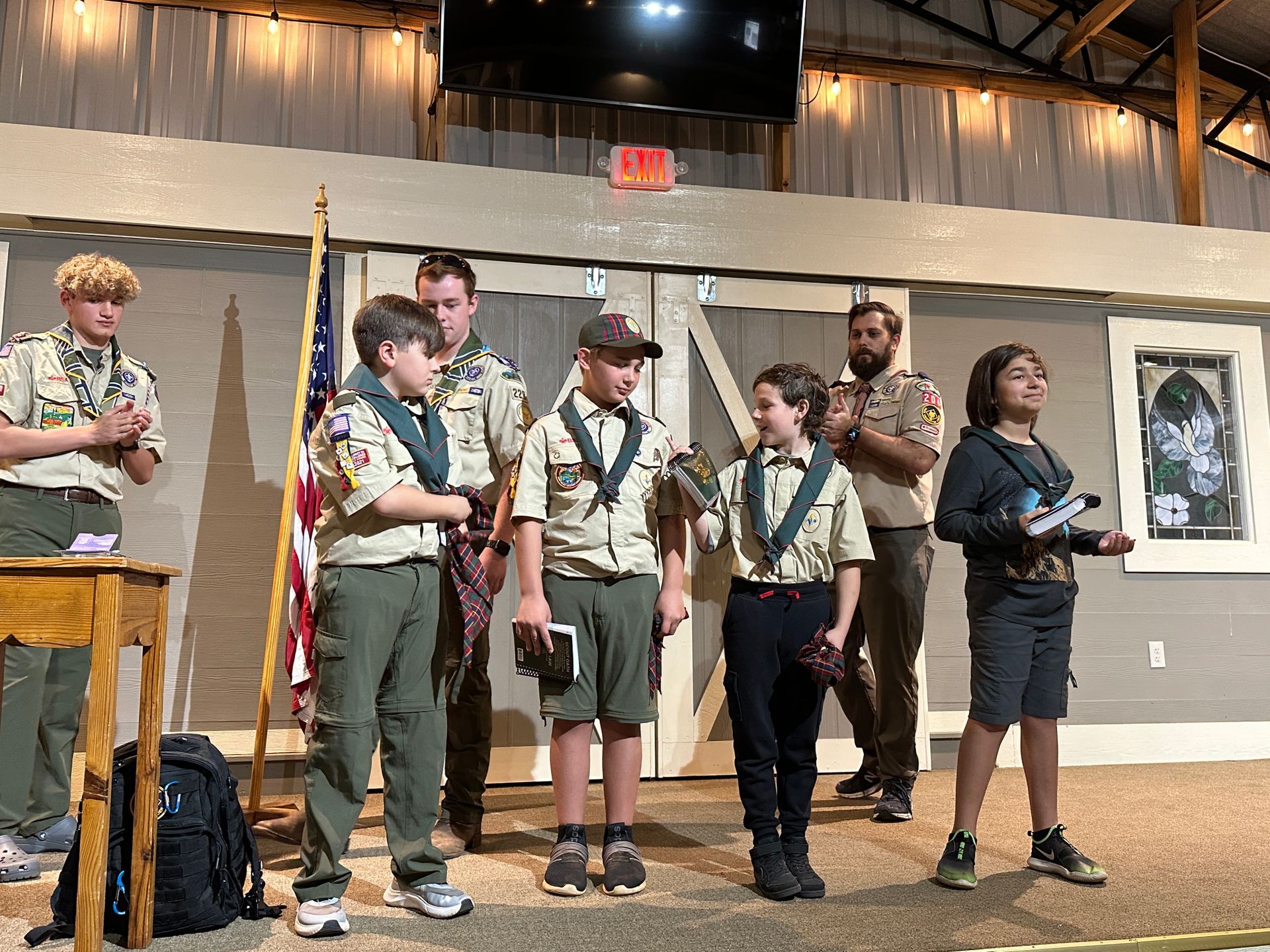 A group of boy scouts are standing on a stage.