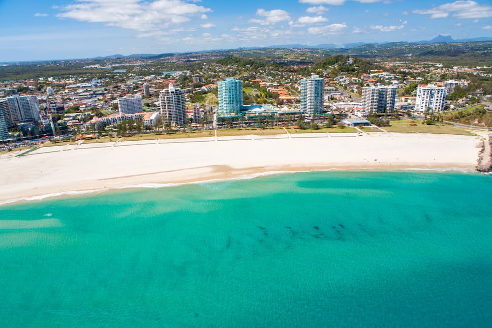 An Aerial View Of A Beach With A City In The Background — Infinity Kitchens & Cabinets in Gold Coast, NSW