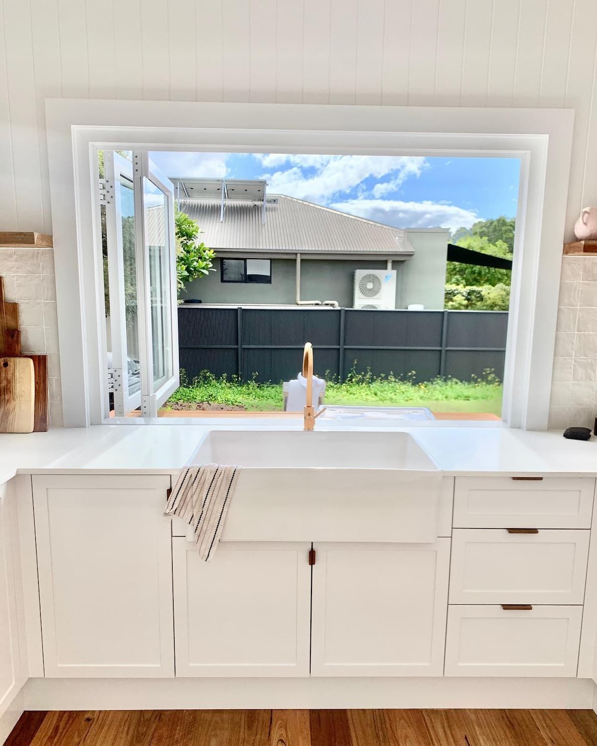 A Kitchen With A Sink And A Window With A View Of The Backyard — Infinity Kitchens & Cabinets in Byron Bay, NSW