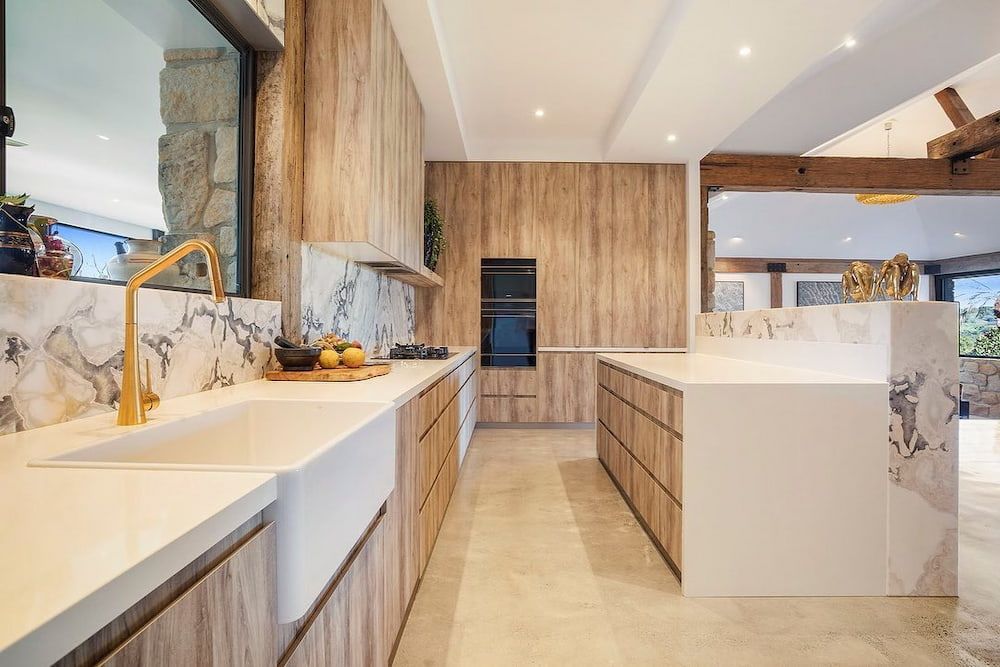 A Kitchen With Wooden Cabinets, White Counter Tops, And A Sink — Infinity Kitchens & Cabinets in Lismore, NSW