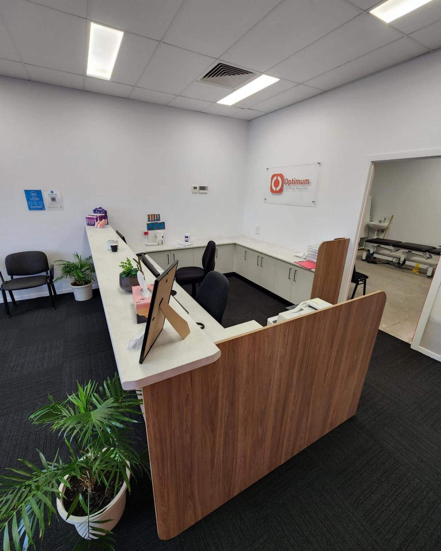 A Reception Area In A Medical Office With A Desk And Chairs — Infinity Kitchens & Cabinets in Alstonville, NSW
