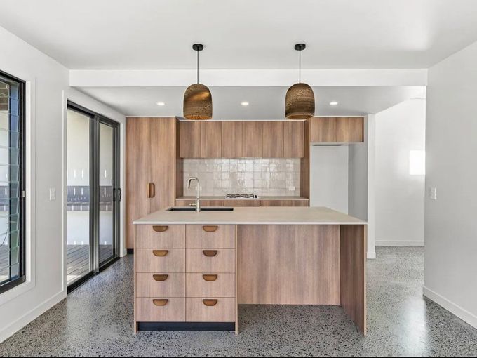 A Kitchen With A Black Refrigerator And White Cabinets in Lismore, NSW— Infinity Kitchens