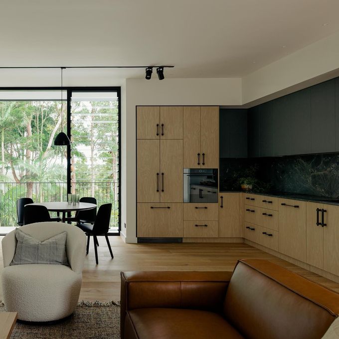 A Bathroom With A White Bathtub And Black Tiles in Lismore, NSW — Infinity Kitchens