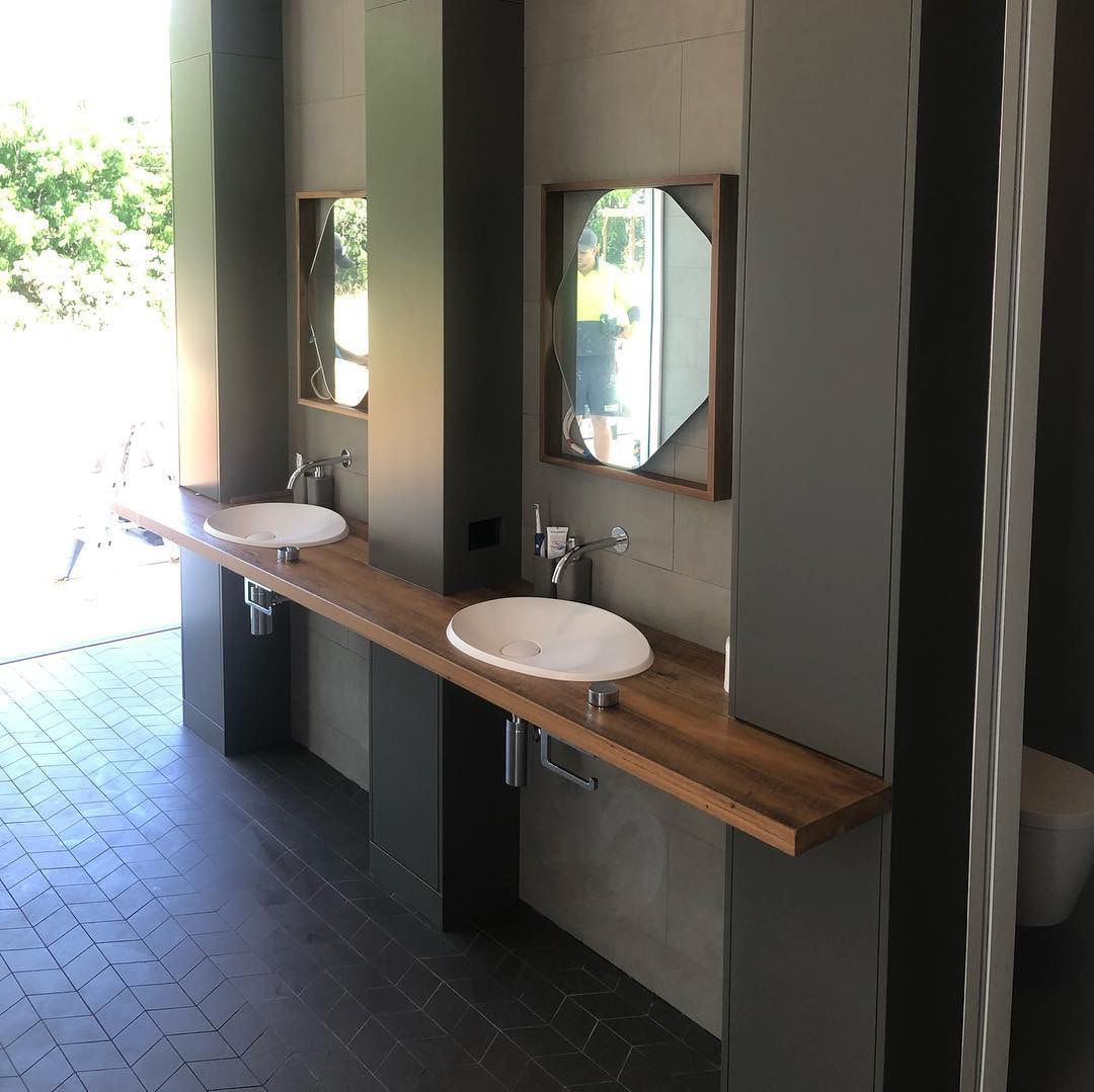 A Bathroom With Two Sinks And A Mirror On The Wall — Infinity Kitchens & Cabinets in Tweed Heads, NSW