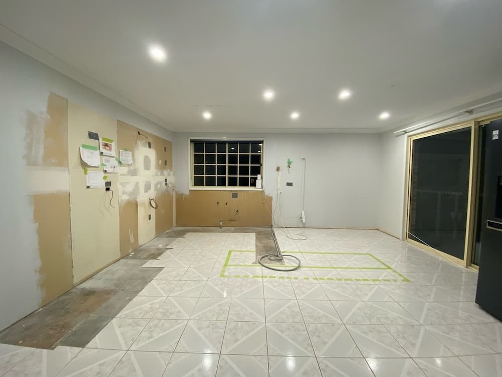 A Contemporary Kitchen Featuring White Tile Flooring and Wooden Cabinets