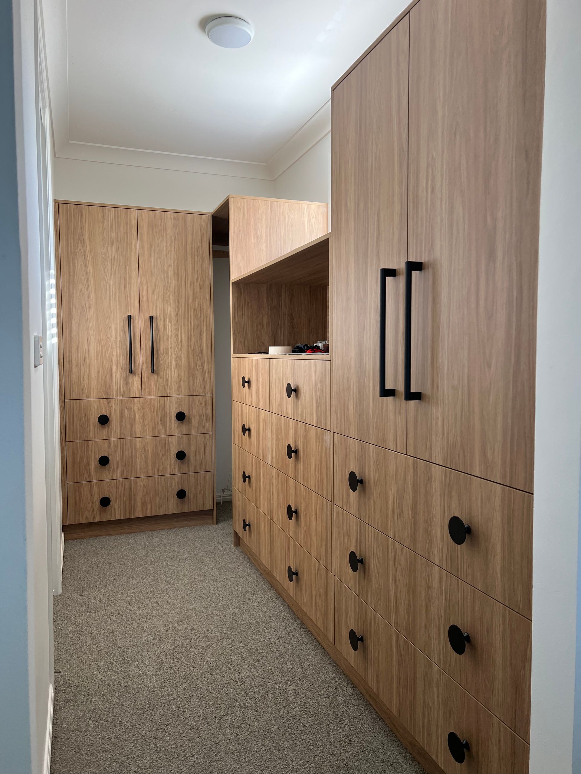 Walk in Wardrobe with Black Handles— Infinity Kitchens & Cabinets in Alstonville, NSW