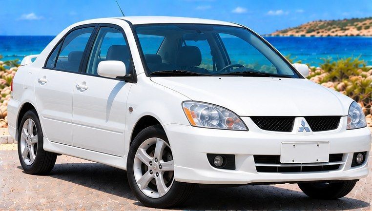 Witte Mitsubishi Lancer huurauto op Curaçao, vooraanzicht