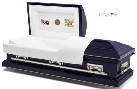 Indigo blue casket with white satin interior and decorative panels on lid