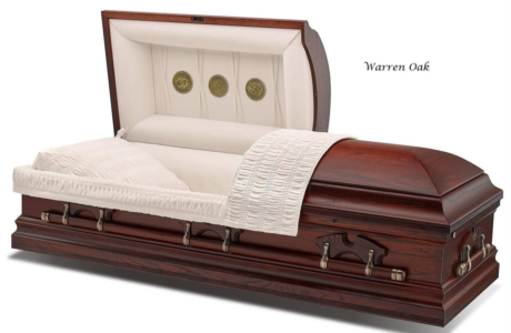 Mahogany casket with open lid and cream satin interior on white background