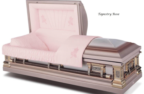 Pink satin-lined casket with the lid open, shown in a studio setting