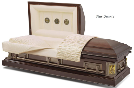 Luxury dark wood casket with cream bedding and gold accents, displayed open on a white background