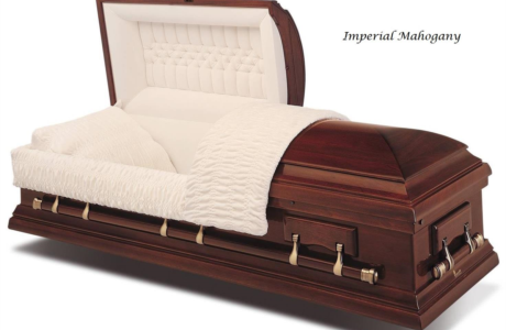 Mahogany casket with cream quilted lining and draped white blanket, shown on a white background
