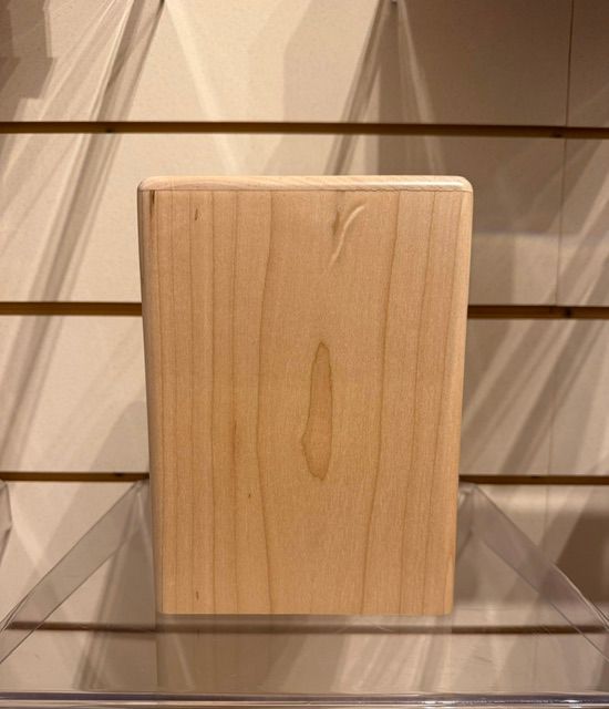 Light wood rectangular block on a slotted display shelf with clear acrylic supports.
