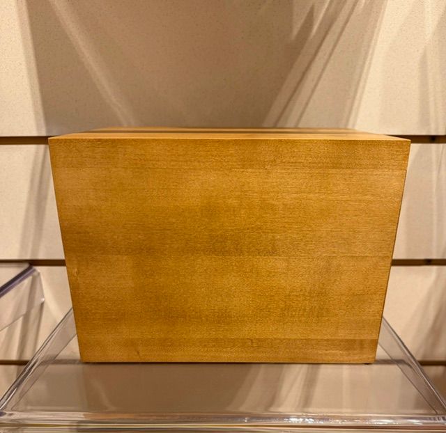 Gold rectangular planter on a clear acrylic shelf against a neutral background