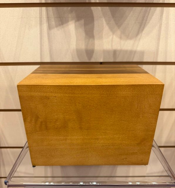 Wooden display box on a clear acrylic stand against a light slatted wall