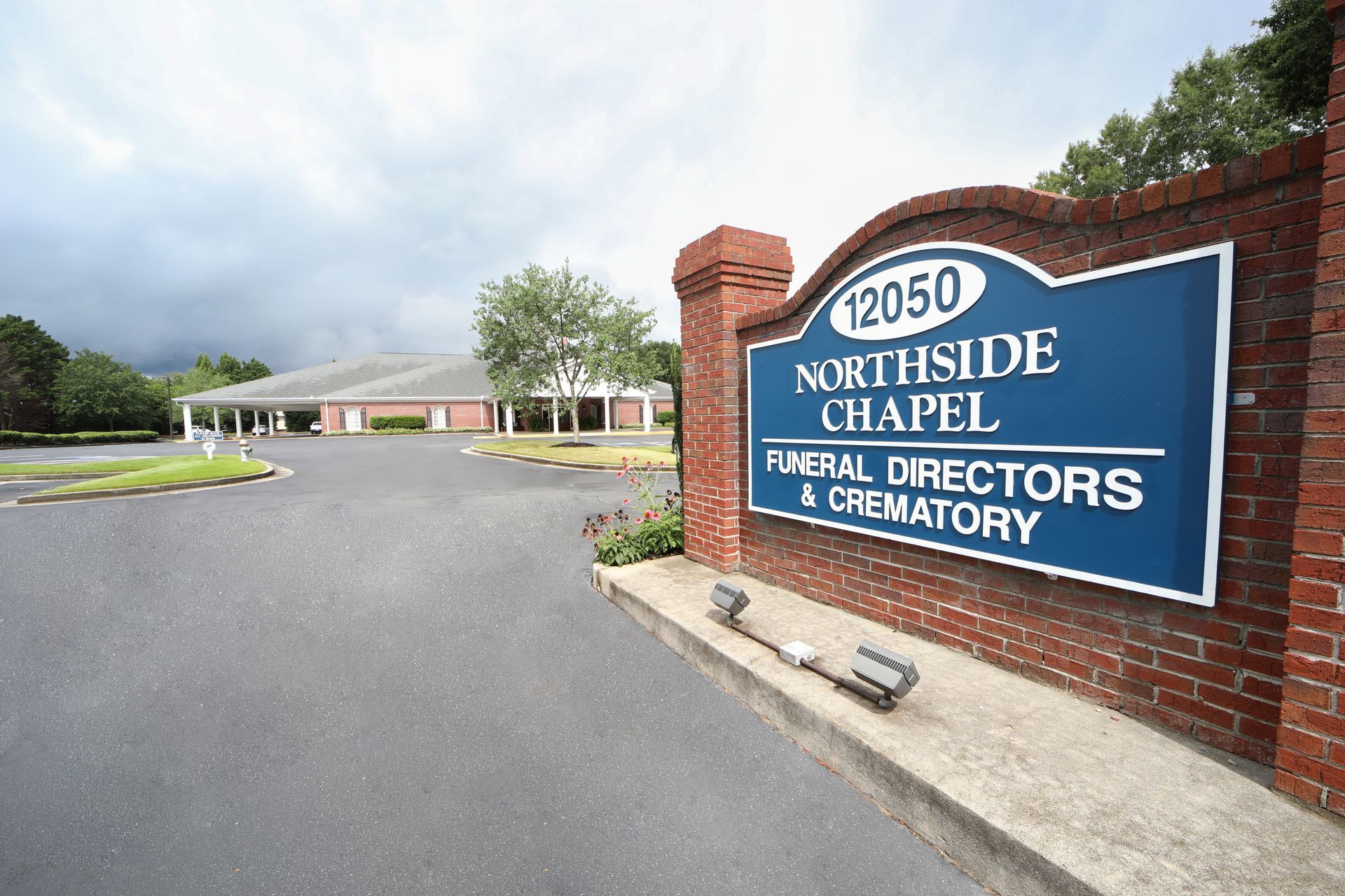 Northside Chapel Funeral Directors and Crematory sign by a driveway entrance