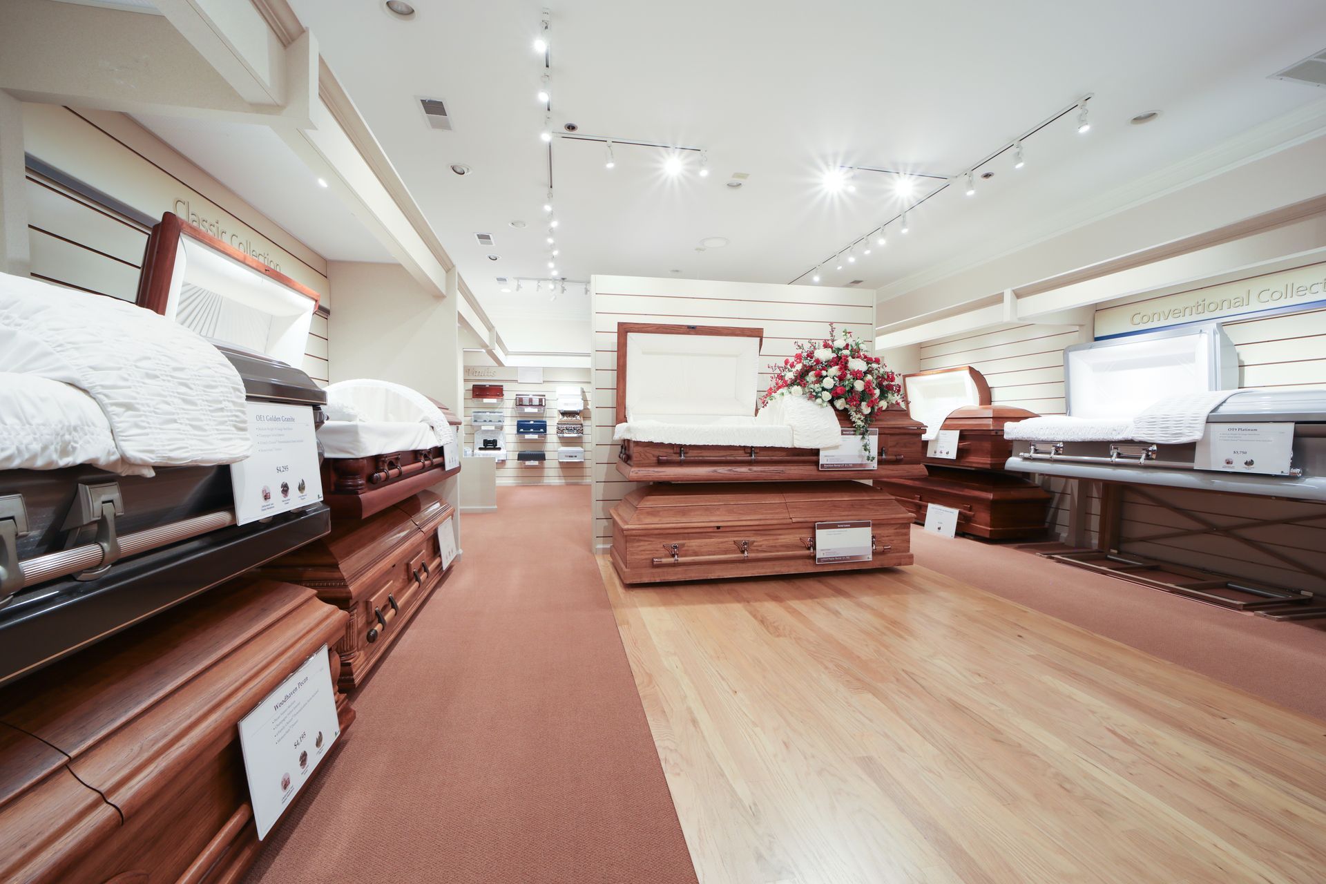 Casket showroom with rows of beds and wooden displays in a bright, modern store