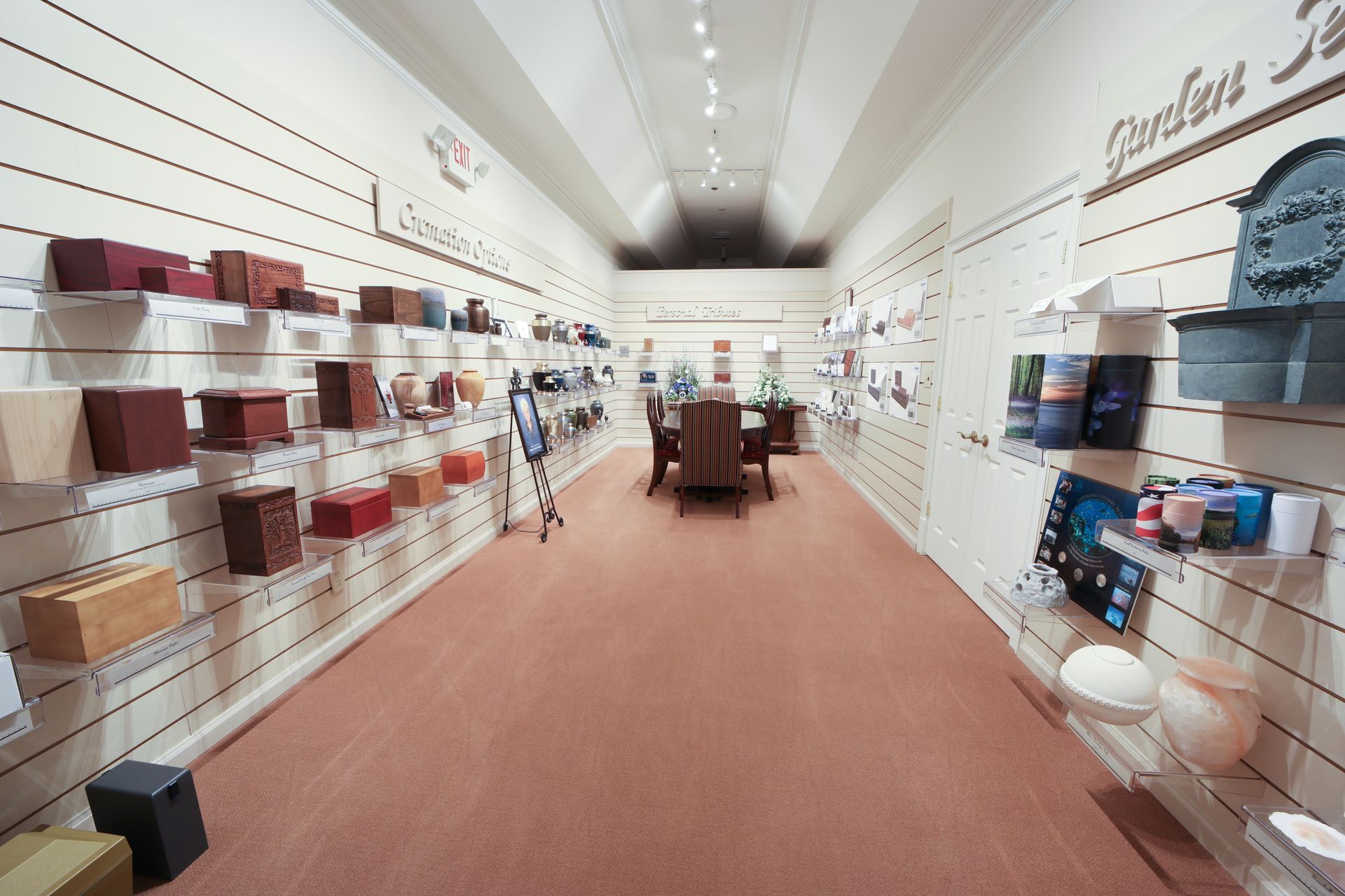 Wide aisle in a home decor store with shelves of boxes and linens on both sides